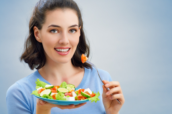 Woman eating salad mixed vegetables Stock Photo 02